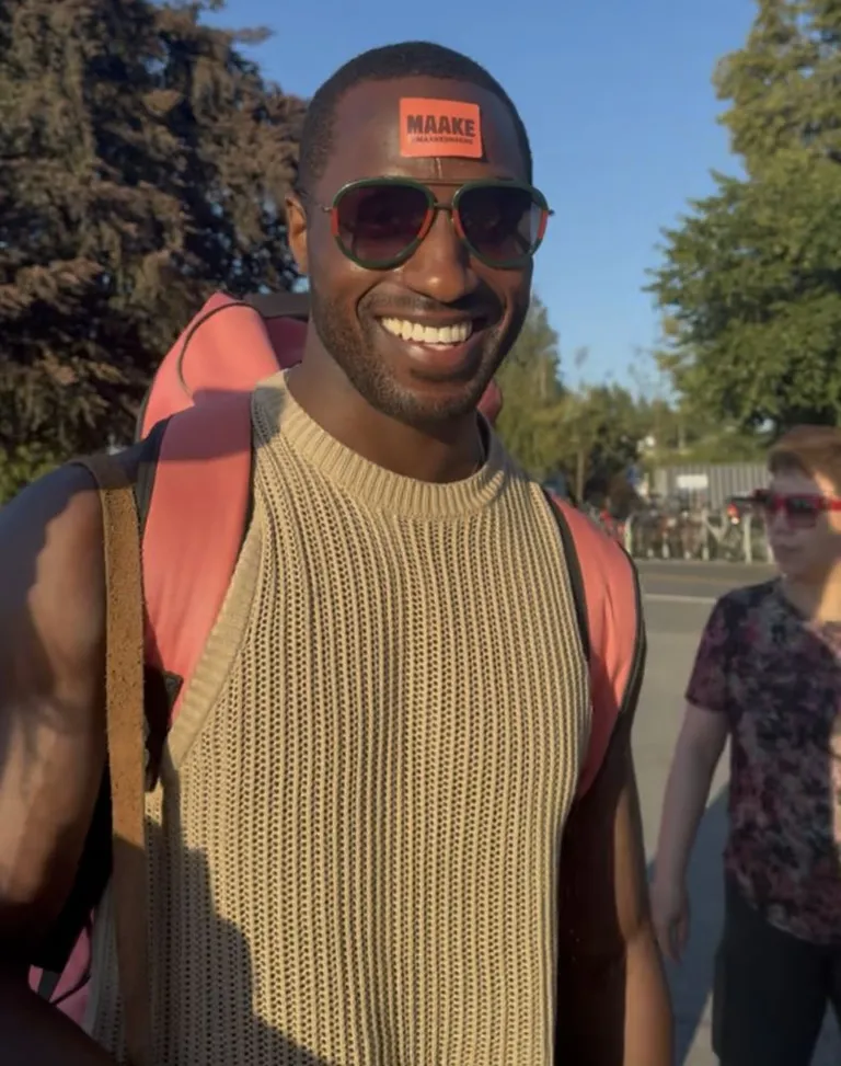 A Maake customer smiling with the crackers at golden hour